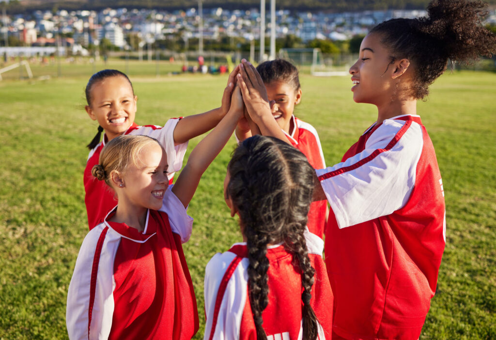 girl soccer team hi five